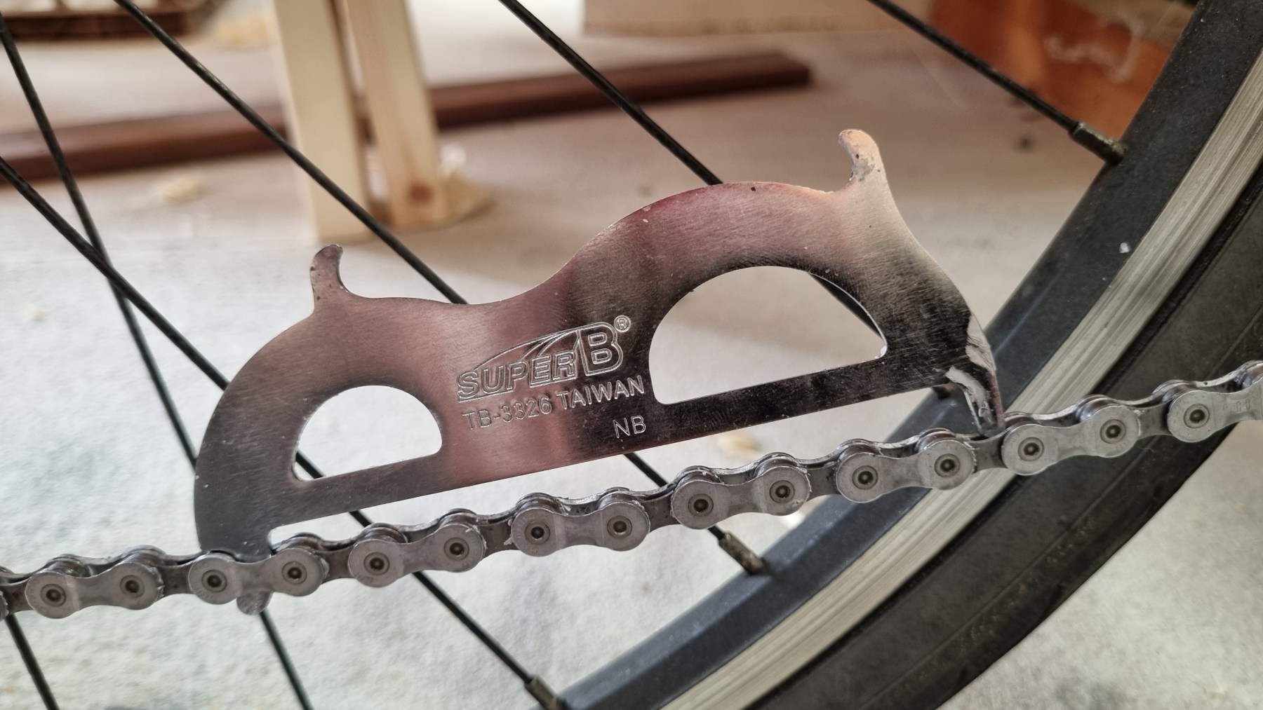 A bicycle chain-wear gauge placed on a chain
