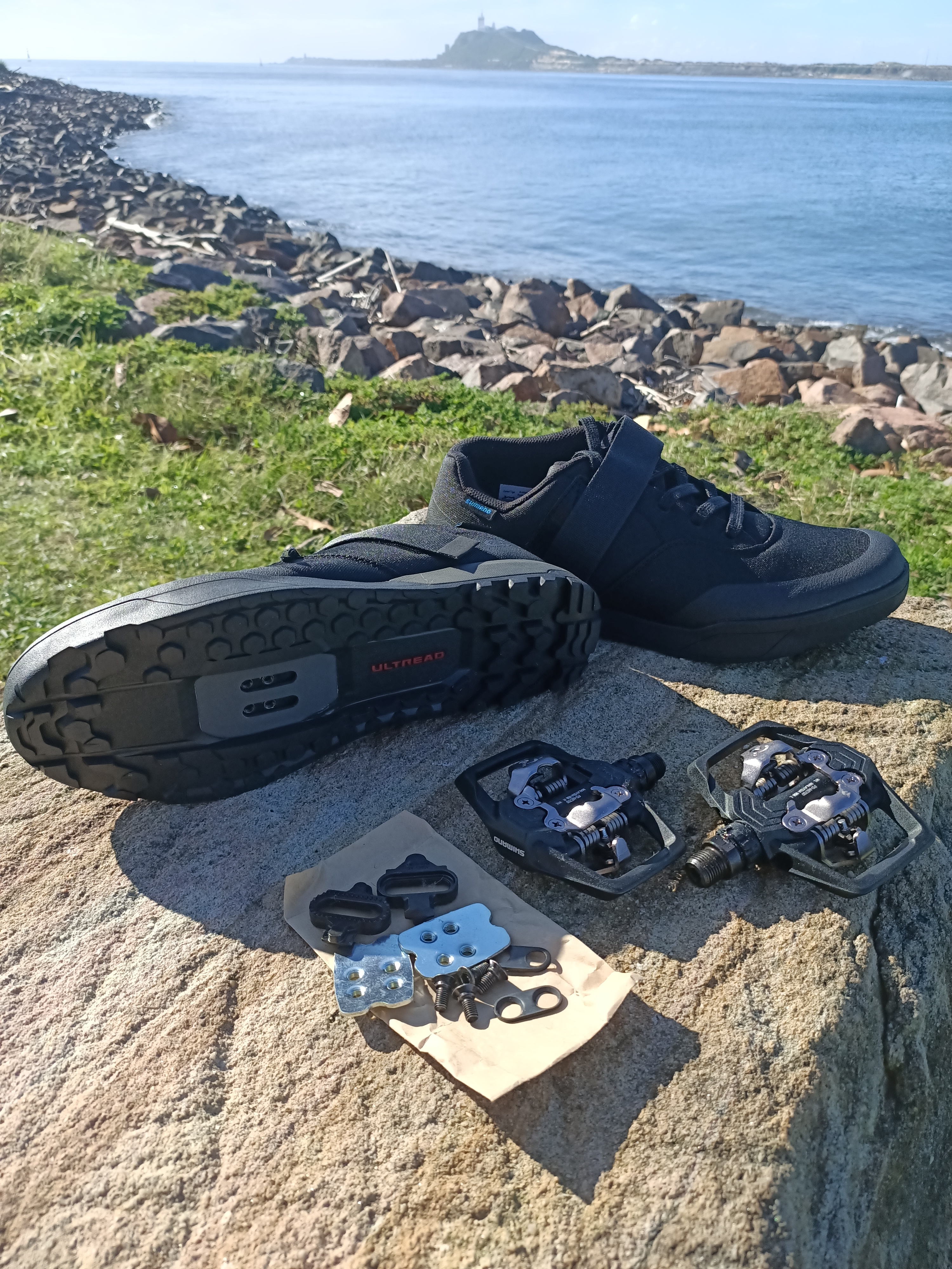 Shimano ME700 SPD pedals, matching SM-SH51 cleats, and GE500 mountain-bike shoes displayed together