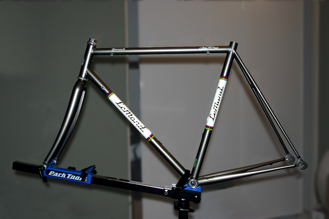 A bicycle frame supported by an axle and bottom-bracket style repair stand